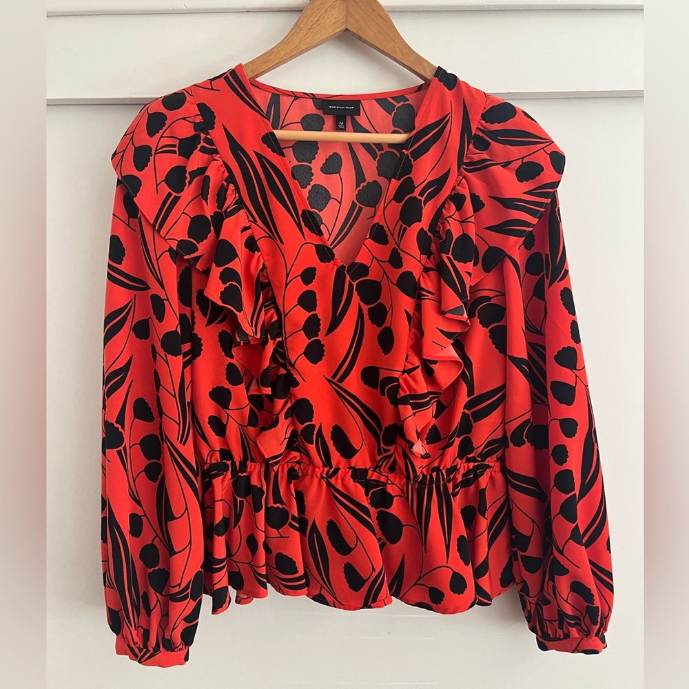 Orange-red top with black floral print